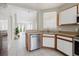 Modern kitchen with stainless steel dishwasher and view to the living room at 6260 Olivedale Dr, Riverview, FL 33578