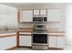 Clean kitchen with stainless steel stove, microwave, and white cabinets at 6260 Olivedale Dr, Riverview, FL 33578