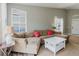Bright living room with comfortable seating, large windows, and a neutral color palette at 6260 Olivedale Dr, Riverview, FL 33578