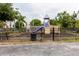 Fenced in playground with play structure and shaded by mature trees at 6260 Olivedale Dr, Riverview, FL 33578