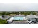 Overhead shot of the beautiful community pool, lake, with lots of lounge seating at 6260 Olivedale Dr, Riverview, FL 33578