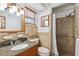 Cozy bathroom featuring a granite-topped vanity and tiled shower with updated fixtures at 6365 32Nd N Ave, St Petersburg, FL 33710