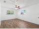 Spacious bedroom showcasing wood floors, neutral walls, and natural light from the windows at 6365 32Nd N Ave, St Petersburg, FL 33710