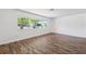 Bright bedroom featuring new flooring and a large window with neighborhood views at 6365 32Nd N Ave, St Petersburg, FL 33710