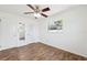 Bedroom featuring wood-look floors, a ceiling fan, a window, and a door to a walk-in closet at 6365 32Nd N Ave, St Petersburg, FL 33710