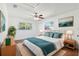 Comfortable bedroom with a ceiling fan, natural light, and tasteful decor with a plush bed at 6365 32Nd N Ave, St Petersburg, FL 33710