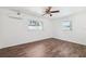 Bright bedroom with wood-look floors, two windows, and a split air conditioning unit at 6365 32Nd N Ave, St Petersburg, FL 33710