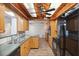 Charming kitchen with wood cabinets, black appliances, and unique wood-beam ceiling at 6365 32Nd N Ave, St Petersburg, FL 33710