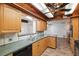 Charming kitchen with wood cabinets, dual sink, and unique wood-beam ceiling at 6365 32Nd N Ave, St Petersburg, FL 33710