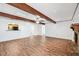 Open living room with wood-look floors, a stone fireplace, and a breakfast bar to the kitchen at 6365 32Nd N Ave, St Petersburg, FL 33710