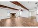 Open living room features a stone fireplace, wood-look floors, and beamed ceilings at 6365 32Nd N Ave, St Petersburg, FL 33710