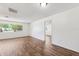 Bright living room featuring wood floors, neutral walls, and a large window showcasing the landscape at 6365 32Nd N Ave, St Petersburg, FL 33710
