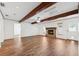 Spacious living room features a stone fireplace, beamed ceilings, and wood-look floors at 6365 32Nd N Ave, St Petersburg, FL 33710