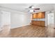 Open living space with wood floors, storage cabinets, and a view into the hall and doorway at 6365 32Nd N Ave, St Petersburg, FL 33710
