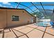 A covered patio offers views of the pool and jacuzzi, set against a clear blue sky at 6365 32Nd N Ave, St Petersburg, FL 33710