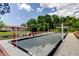 Community bocce ball court with seating area, landscaping, and nearby buildings at 6428 Gloria Dr # 21, New Port Richey, FL 34653