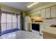 Bright kitchen with white appliances and cabinetry, flowing to an outdoor balcony at 6428 Gloria Dr # 21, New Port Richey, FL 34653