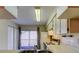 Open kitchen layout with a view to the balcony, equipped with essential appliances at 6428 Gloria Dr # 21, New Port Richey, FL 34653