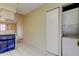 Kitchen with stacked laundry machines adjacent to the living area at 6428 Gloria Dr # 21, New Port Richey, FL 34653