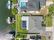 Aerial shot of home featuring a screened-in pool, lush backyard, boat dock, and canal front access at 6604 Dolphin Cove Dr, Apollo Beach, FL 33572