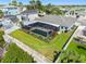 Private backyard featuring a screened-in pool, manicured lawn, and waterfront access with a boat dock at 6604 Dolphin Cove Dr, Apollo Beach, FL 33572