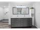 This primary bathroom features a double vanity, a large mirror, ship lap walls, and a glass enclosed shower at 6604 Dolphin Cove Dr, Apollo Beach, FL 33572