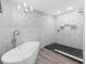 Modern primary bath with sleek fixtures, a freestanding tub, walk-in shower with black tile, and bright natural light at 6604 Dolphin Cove Dr, Apollo Beach, FL 33572