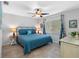 Comfortable bedroom with a ceiling fan and natural light, offering a cozy retreat with beach-themed curtains at 6604 Dolphin Cove Dr, Apollo Beach, FL 33572