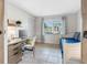Bright bedroom featuring tile floors, daybed, and a desk with natural light at 6604 Dolphin Cove Dr, Apollo Beach, FL 33572