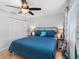 Comfortable bedroom with a ceiling fan and natural light, complemented by beach-themed accents and window treatments at 6604 Dolphin Cove Dr, Apollo Beach, FL 33572