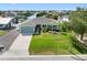 Desirable home with a spacious driveway, manicured lawn, and charming landscaping, providing an inviting entrance at 6604 Dolphin Cove Dr, Apollo Beach, FL 33572