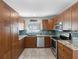 Modern kitchen featuring stainless steel appliances, granite counters, tiled backsplash, and ample storage space at 6604 Dolphin Cove Dr, Apollo Beach, FL 33572