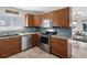Well-equipped kitchen boasts granite counters, stainless steel appliances, tiled backsplash, and ample cabinet space at 6604 Dolphin Cove Dr, Apollo Beach, FL 33572