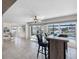 Indoor/outdoor living with tile flooring, bar seating area, ceiling fan, and beautiful views of the pool and waterway at 6604 Dolphin Cove Dr, Apollo Beach, FL 33572