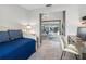 Bright bedroom featuring tile floors, daybed, and a desk leading to the living room at 6604 Dolphin Cove Dr, Apollo Beach, FL 33572
