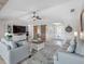 Bright living room featuring plush seating, entertainment center, stylish decor, and sliding barn doors to adjacent room at 6604 Dolphin Cove Dr, Apollo Beach, FL 33572