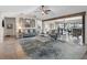 Bright living area showcasing stylish furniture, a decorative beam, and seamless access to the outdoor bar and pool at 6604 Dolphin Cove Dr, Apollo Beach, FL 33572