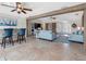 Inviting living room featuring tile floors, ceiling fans, and sliding barn doors, offering a blend of comfort and rustic charm at 6604 Dolphin Cove Dr, Apollo Beach, FL 33572