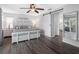 This spacious main bedroom features a view into the ensuite bathroom with a sliding barn door, and lots of natural light at 6604 Dolphin Cove Dr, Apollo Beach, FL 33572