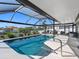Gorgeous pool with clear blue water, screened-in lanai, and beautiful waterfront views offering the perfect outdoor oasis at 6604 Dolphin Cove Dr, Apollo Beach, FL 33572