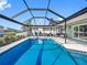 Spacious lanai with a pool, dining and living area for outdoor entertainment at 6604 Dolphin Cove Dr, Apollo Beach, FL 33572