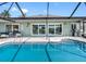 Inviting pool overlooking lush backyard offering outdoor entertainment at 6604 Dolphin Cove Dr, Apollo Beach, FL 33572