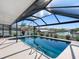 Stunning waterfront pool area surrounded by lush landscaping, providing a private retreat at 6604 Dolphin Cove Dr, Apollo Beach, FL 33572