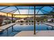 Inviting screened-in pool area with comfortable lounge chairs overlooking the serene waterfront canal at 6604 Dolphin Cove Dr, Apollo Beach, FL 33572