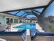 Inviting screened-in pool with lounge chairs and dining table for outdoor enjoyment at 6604 Dolphin Cove Dr, Apollo Beach, FL 33572