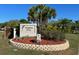 Dolphin Cove community sign with lush landscaping and well-maintained entrance at 6604 Dolphin Cove Dr, Apollo Beach, FL 33572