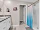 Bathroom featuring granite counters, white cabinets, and a shower with a curtain at 6653 Mineral Springs Rd, New Port Richey, FL 34653