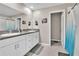 Bathroom with granite counters, double sinks, white cabinets, and a shower with a curtain at 6653 Mineral Springs Rd, New Port Richey, FL 34653