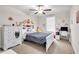 Bright bedroom featuring a ceiling fan, plush carpet, and charming decor at 6653 Mineral Springs Rd, New Port Richey, FL 34653