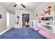 Cozy bedroom with walk-in closet and white-painted furnishings and decor at 6653 Mineral Springs Rd, New Port Richey, FL 34653